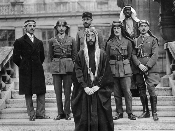 Emir Feisal’s delegation at Versailles, during the Paris Peace Conference of 1919. Left to right: Rustum Haidar, Nuri as-Said, Prince Feisal, Captain Pisani (behind Feisal), T. E. Lawrence, Feisal’s slave, Captain Hassan Khadri.
