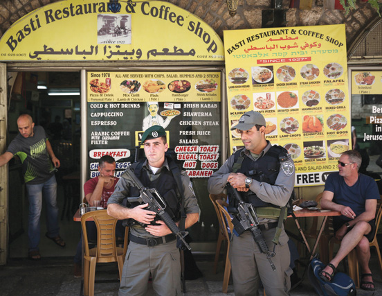 Israeli Border Police keep watch outside an Arab restaurant in Jerusalem’s Old City. (Photo by Hadas Parush/Flash90.)