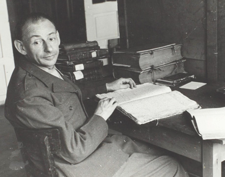 Gershom Scholem in Offenbach, Germany, 1946, identifying Hebrew manuscripts stolen by the Nazis. (Courtesy of the Gershom Scholem Archive, The National Library of Israel.)