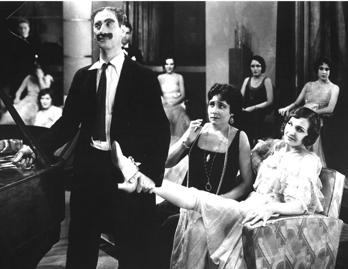 Groucho Marx as Captain Jeffrey Edgar Spaulding with Margaret Dumont, right, in a scene from Animal Crackers, 1930. (Courtesy of the Everett Collection.) 