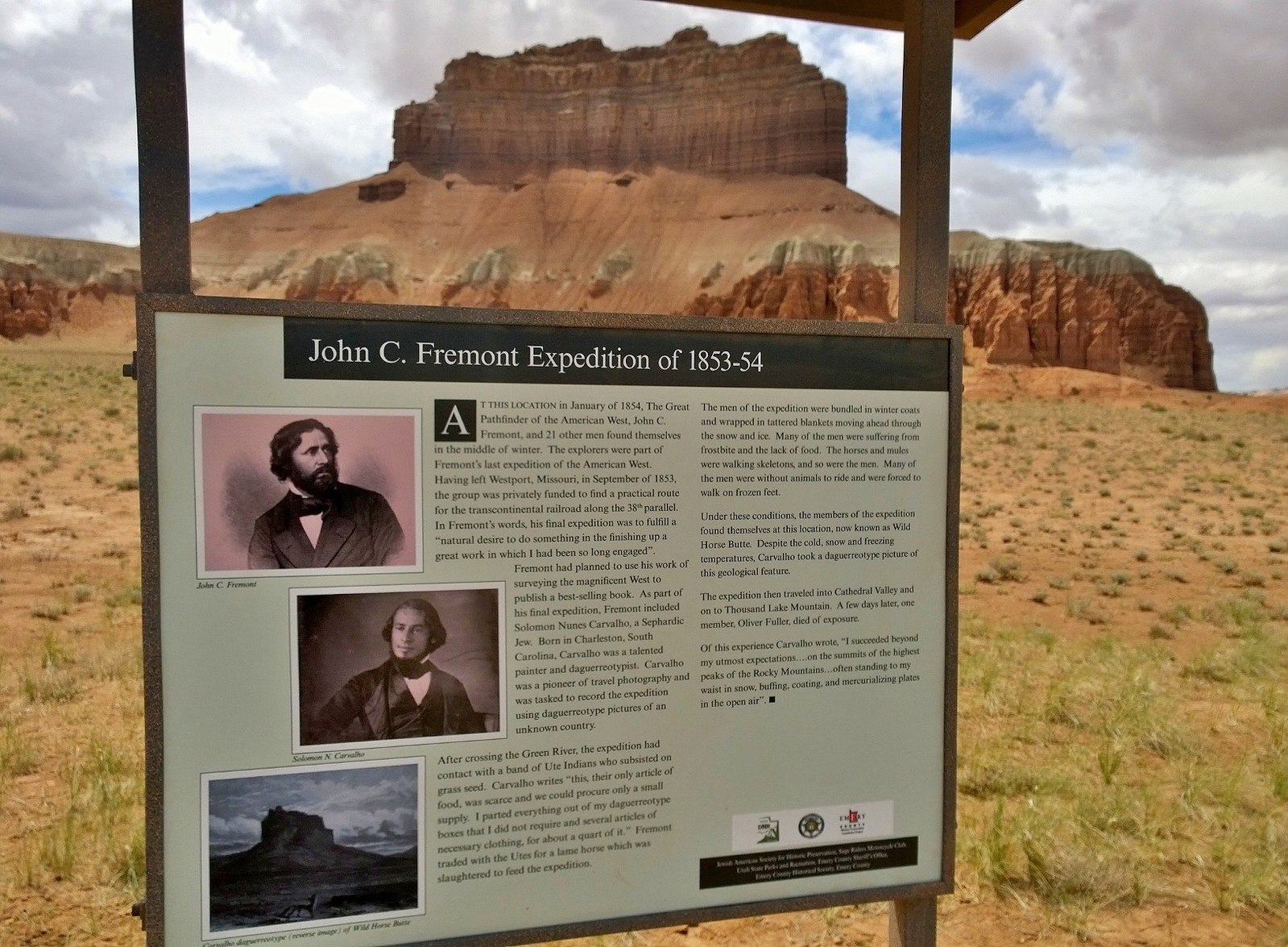 An plaque that explains the significance of the location and has a viewing window through which one can see an impressive rock formation.
