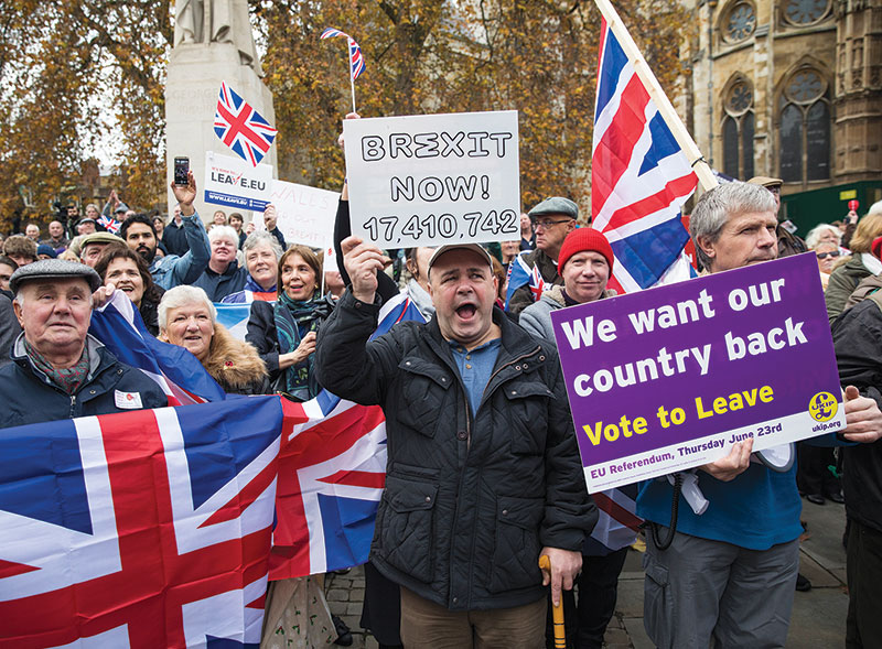 Photo of pro-Brexit demonstrators holding Union Jack flags and signs