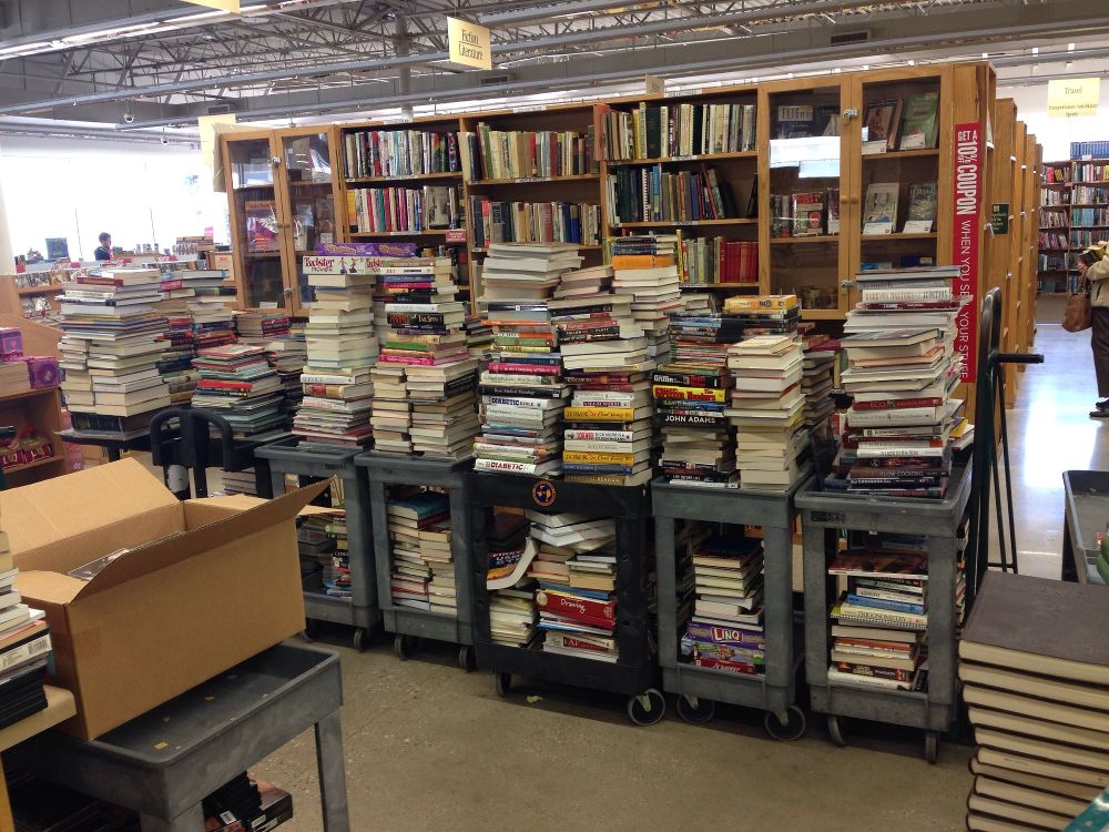 Stacks of books and bookshelves inside a bookstore